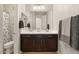Bathroom with double sink vanity, framed mirror, and shower behind a patterned curtain at 258 Castellari Dr, Las Vegas, NV 89138