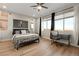 Bedroom with a large window, fan, wooden flooring, and ample natural light and Vegas Golden Nights flag at 258 Castellari Dr, Las Vegas, NV 89138
