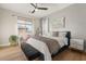 Bright bedroom featuring stylish furniture, a ceiling fan, and a window with natural light at 258 Castellari Dr, Las Vegas, NV 89138