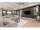 Stylish living room with a sectional sofa, modern decor, and a large flat-screen television at 258 Castellari Dr, Las Vegas, NV 89138