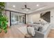 Bright living room features recessed lighting, sliding glass doors to patio, and comfortable gray sofa at 258 Castellari Dr, Las Vegas, NV 89138