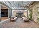 A covered patio with brick pavers, stylish fireplace, outdoor seating, and vines growing up wall at 258 Castellari Dr, Las Vegas, NV 89138