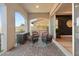 Covered patio features brick pavers and stylish seating for an outdoor living space at 258 Castellari Dr, Las Vegas, NV 89138