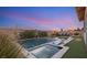 Gorgeous swimming pool and spa surrounded by lounge chairs and well-maintained landscaping at 258 Castellari Dr, Las Vegas, NV 89138