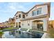 Inviting backyard pool with outdoor furniture, landscaping, and well-maintained artificial turf at 258 Castellari Dr, Las Vegas, NV 89138