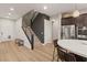 Modern staircase and kitchen combination with dark wood cabinets and stainless steel appliances at 258 Castellari Dr, Las Vegas, NV 89138