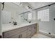 Luxurious bathroom with double vanity, modern fixtures, and glass-enclosed shower at 2603 Savannah Springs Ave, Henderson, NV 89052