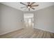 Bedroom with open doorway, ceiling fan, and view into the living room and dining area at 2603 Savannah Springs Ave, Henderson, NV 89052