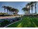 A scenic view of Sun City Anthem's lushly landscaped entrance with rows of palm trees at 2603 Savannah Springs Ave, Henderson, NV 89052