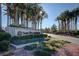 A scenic view of Sun City Anthem's lushly landscaped entrance with rows of palm trees at 2603 Savannah Springs Ave, Henderson, NV 89052