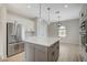 Bright kitchen with a large island, stainless steel appliances, and elegant pendant lighting at 2603 Savannah Springs Ave, Henderson, NV 89052