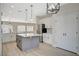 Modern kitchen featuring a center island, stainless steel appliances, and updated lighting fixtures at 2603 Savannah Springs Ave, Henderson, NV 89052
