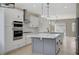 Beautiful kitchen featuring a center island, sleek stainless steel appliances, and modern finishes at 2603 Savannah Springs Ave, Henderson, NV 89052