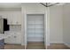 Walk-in pantry providing ample storage, with shelving, adjacent to kitchen and appliances at 2603 Savannah Springs Ave, Henderson, NV 89052