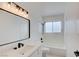 Modern bathroom featuring a stylish vanity, a shower-tub combo, and contemporary fixtures at 2716 Ferrin Rd, Las Vegas, NV 89117