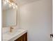 Modern powder room with stylish gold fixtures and a unique mirror at 2716 Ferrin Rd, Las Vegas, NV 89117