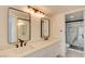 Modern bathroom featuring double sinks, a white countertop, and a glass-enclosed shower at 2716 Ferrin Rd, Las Vegas, NV 89117