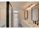 Bathroom featuring a double vanity, modern lighting, and a large mirror at 2716 Ferrin Rd, Las Vegas, NV 89117