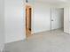 Minimalist bedroom featuring tile flooring, white walls, and double doors at 2716 Ferrin Rd, Las Vegas, NV 89117