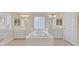 Primary bathroom featuring dual vanities and sinks with a jetted soaking tub at 3065 Lenoir St, Las Vegas, NV 89135