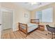 Bedroom featuring wooden floors, desk and a window at 3065 Lenoir St, Las Vegas, NV 89135
