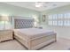 Bedroom with a stylish tufted headboard, side tables with lamps and shuttered window at 3065 Lenoir St, Las Vegas, NV 89135