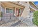 Charming home with a red door, a covered porch, and a well-manicured front yard at 3065 Lenoir St, Las Vegas, NV 89135