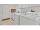 Bright laundry room with tile flooring, washer, dryer, and ample storage space at 3065 Lenoir St, Las Vegas, NV 89135