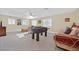 Expansive upstairs loft area featuring a foosball table, seating, and abundant natural light at 3065 Lenoir St, Las Vegas, NV 89135