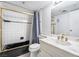 A bathroom showcasing a shower-tub combination, a mirror, and a sink with a marble countertop at 3141 Pinehurst Dr # C, Las Vegas, NV 89109