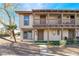 Inviting townhome featuring a cozy balcony, neutral stucco, and low maintenance desert landscaping at 3141 Pinehurst Dr # C, Las Vegas, NV 89109