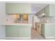 A functional kitchen featuring light green cabinets, white appliances and plenty of counter space at 3141 Pinehurst Dr # C, Las Vegas, NV 89109