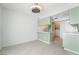 Bright open kitchen area with light green cabinets, and modern fan, seamlessly flowing into the living area at 3141 Pinehurst Dr # C, Las Vegas, NV 89109