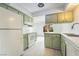 Well-lit kitchen featuring white appliances and ample cabinet space at 3141 Pinehurst Dr # C, Las Vegas, NV 89109