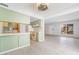 Bright, open-concept living room with light wood floors and a large window, seamlessly connecting to the kitchen at 3141 Pinehurst Dr # C, Las Vegas, NV 89109