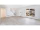 Bright living space featuring light wood floors, a staircase, and large window, creating an airy atmosphere at 3141 Pinehurst Dr # C, Las Vegas, NV 89109