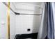 A bathroom showcasing a shower-tub combination with black and white tiled walls and a shower curtain at 3141 Pinehurst Dr # C, Las Vegas, NV 89109