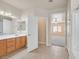 Bright bathroom featuring a wood vanity with dual sinks and a shower-tub combo at 33 Gentilly Lace Ave, Henderson, NV 89002
