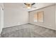 Bedroom featuring plush gray carpet, ceiling fan, and natural light from the window at 33 Gentilly Lace Ave, Henderson, NV 89002