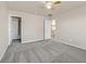 Bedroom featuring plush gray carpet, ceiling fan, and ample closet space, perfect for a relaxing retreat at 33 Gentilly Lace Ave, Henderson, NV 89002