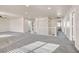 Spacious hallway featuring neutral walls, plush gray carpet, white railing and multiple doors for easy access at 33 Gentilly Lace Ave, Henderson, NV 89002
