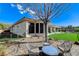 Spacious backyard featuring a large patio, lush artificial turf, and mature landscaping, perfect for entertaining at 33 Hassayampa Trl, Henderson, NV 89052