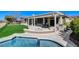 Backyard with outdoor spa and pool surrounded by lawn and beautiful landscaping at 33 Hassayampa Trl, Henderson, NV 89052