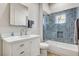 Stylish bathroom showcasing a white vanity, a tub with hexagon tile, and modern fixtures for a luxurious feel at 33 Hassayampa Trl, Henderson, NV 89052