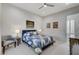 Cozy bedroom boasts a patterned quilt bed and modern art providing a tranquil and stylish space at 33 Hassayampa Trl, Henderson, NV 89052