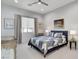 Bright bedroom featuring a patterned quilt bed, a window with curtains, and art creating a serene space at 33 Hassayampa Trl, Henderson, NV 89052