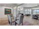 Dining area with seating for six, modern light fixture, and an open view into the living room at 33 Hassayampa Trl, Henderson, NV 89052