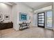 Light-filled foyer with decorative console table, artwork, tile floors, and sleek front door with sidelights at 33 Hassayampa Trl, Henderson, NV 89052