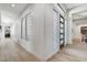 Bright hallway with wood-look tile flooring and glass block window accents at 33 Hassayampa Trl, Henderson, NV 89052