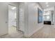 Spacious hallway leading to laundry area, with bright lighting and white trim at 33 Hassayampa Trl, Henderson, NV 89052